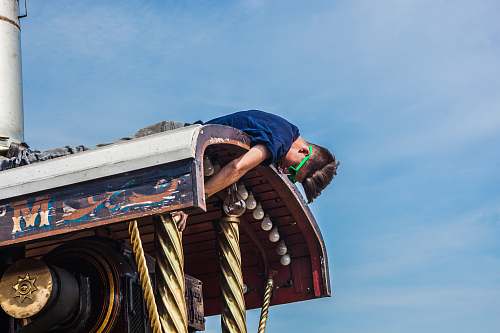 faiground man on top of metal roof at daytime traction engine